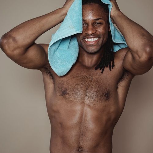 Portrait of a smiling confident man after a workout session.